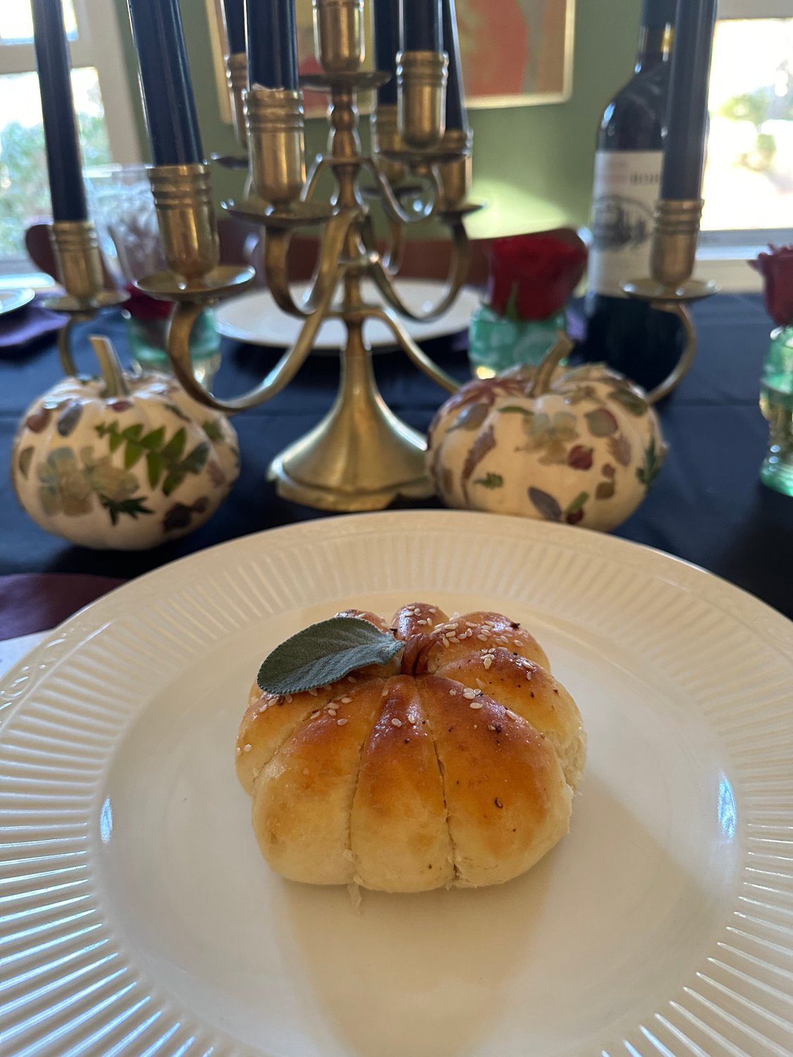 Pumpkin-shaped roll on dinner plate