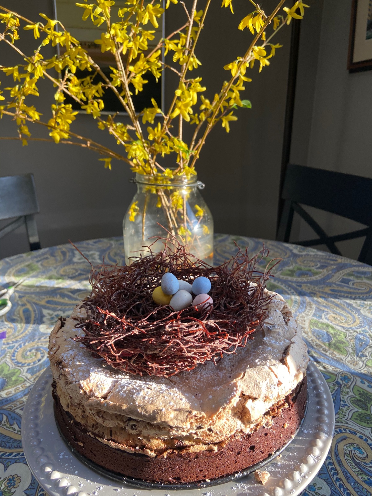 Flourless chocolate cake topped with meringue and a vermicelli bird's nest